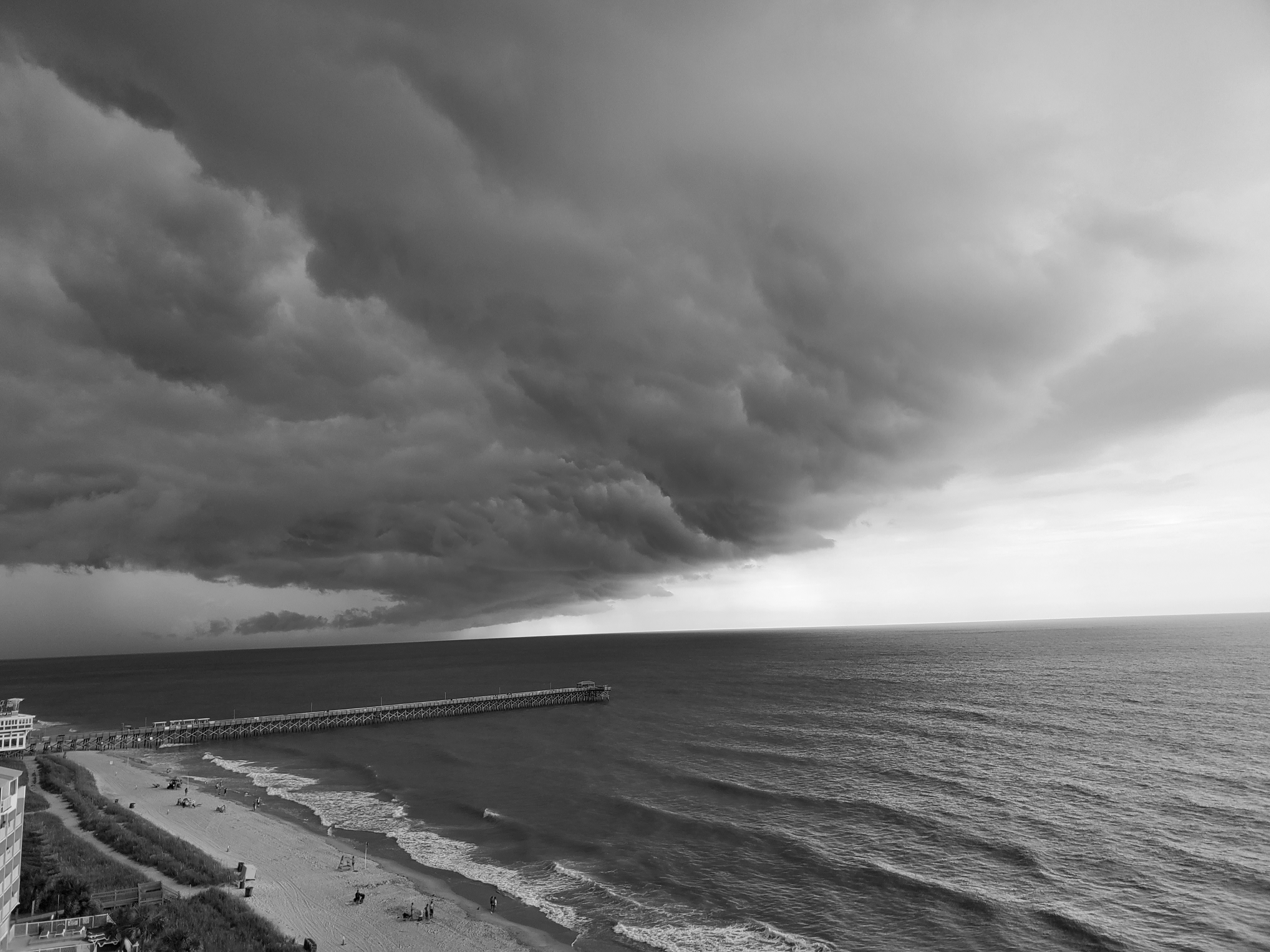 A picture of a storm over a beach.